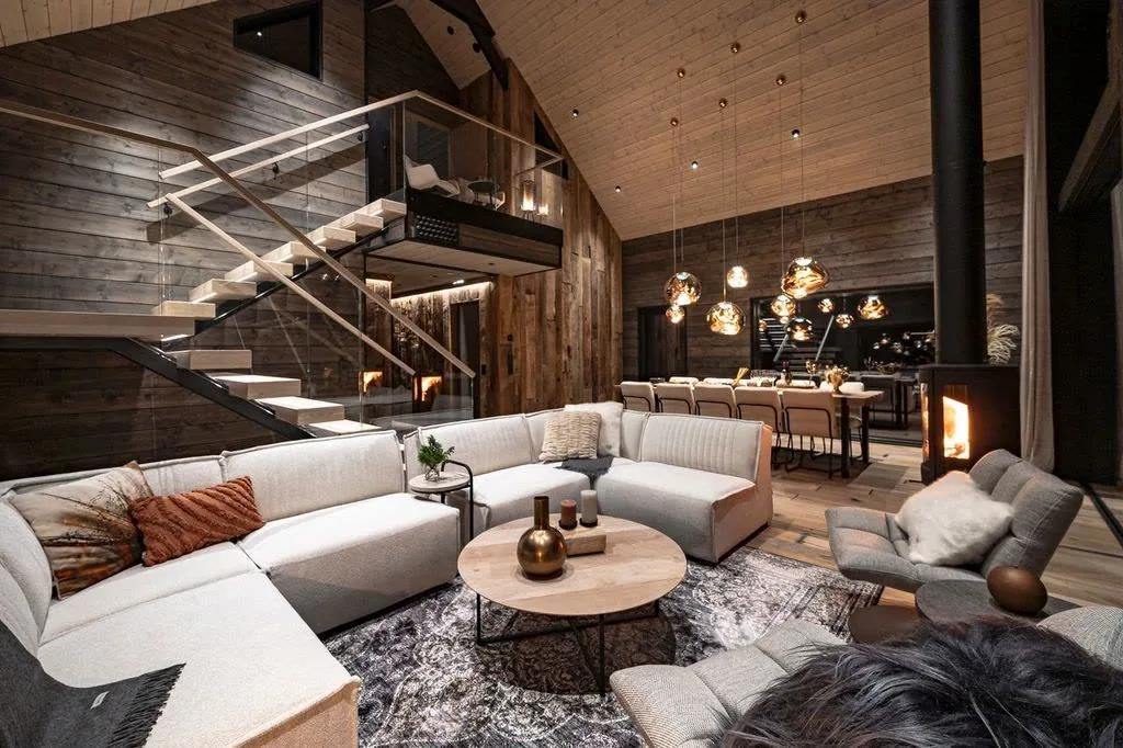 Living room of Grand Panoramic with a large sofa, fireplace and open staircase