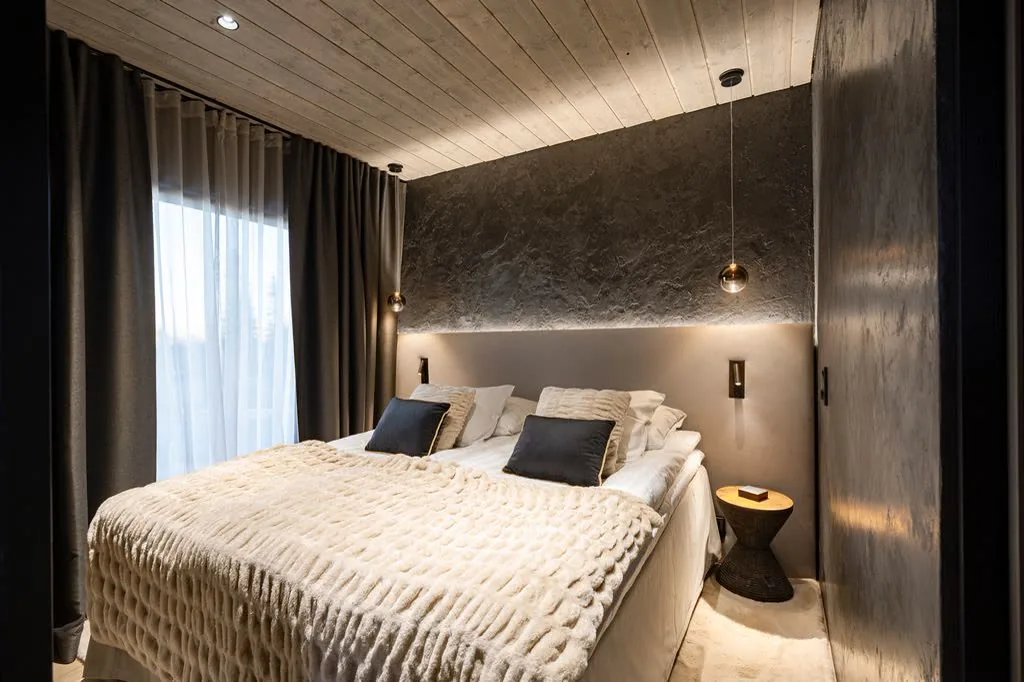 Bedroom in Grand Panoramic with a soft fur throw and warm pendant lighting