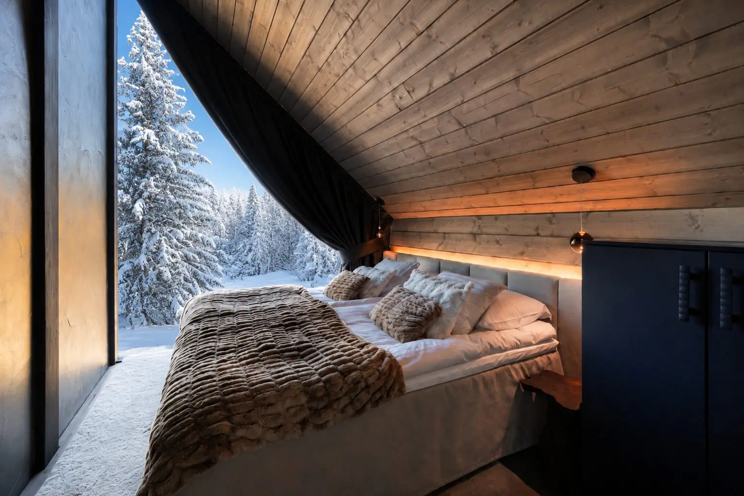 King size bedroom in Grand Hideaway with a window onto snow covered forest